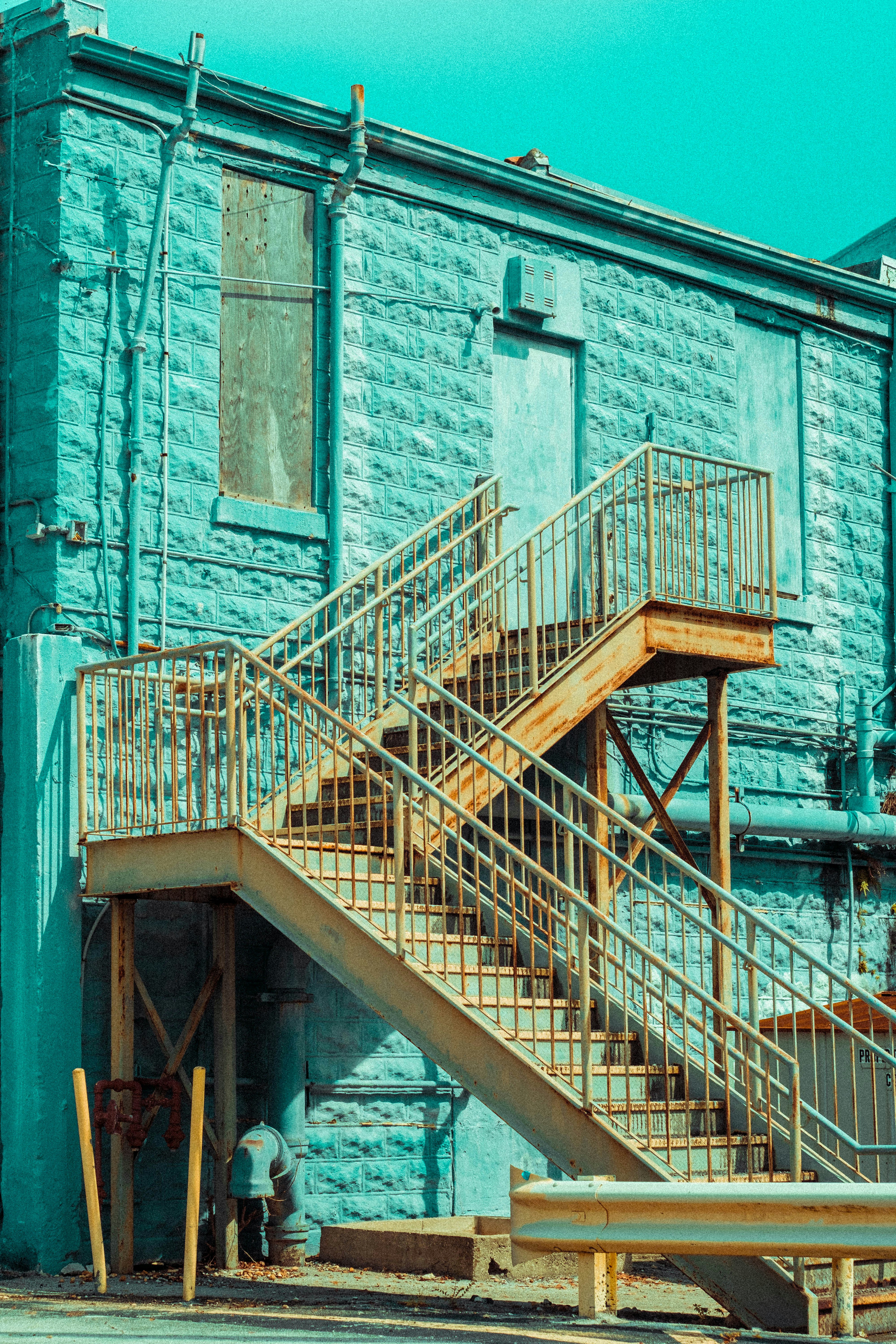 brown wooden staircase on gray concrete building